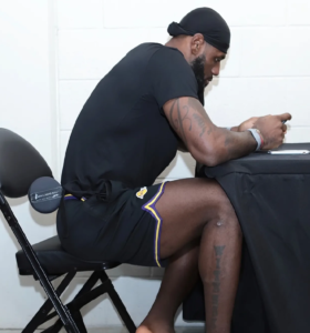 LeBron James sitting with McKenzie lumbar roll pillow for back support