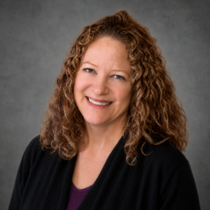 portrait photo of Wicker Park billing manager, Paula Halfman, against a gray background